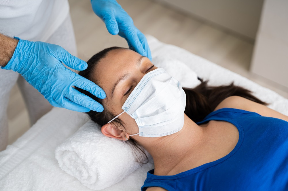 Massage with mask and gloves