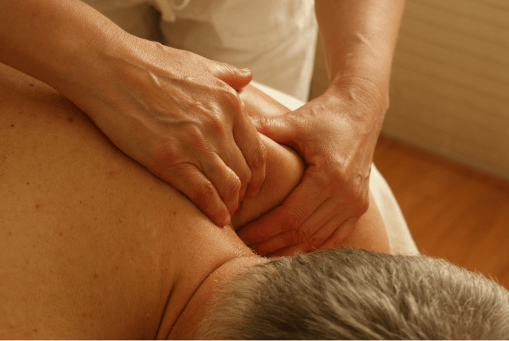 Massage Therapist Massaging Old Man’s Back