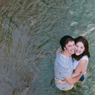 Couple smiling while standing in a creek