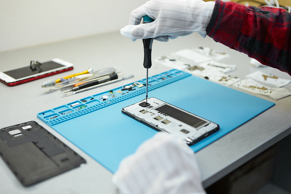 technician-antistatic-gloves-using-screwdriver-disassemble-borken-mobile-phone-going-repai