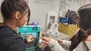 Girls using the Robo E4 3D printer