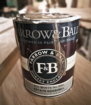 A tin of Farrow & Ball Estate Eggshell in the shade All White, used for traditional hand-painting of wooden joinery.