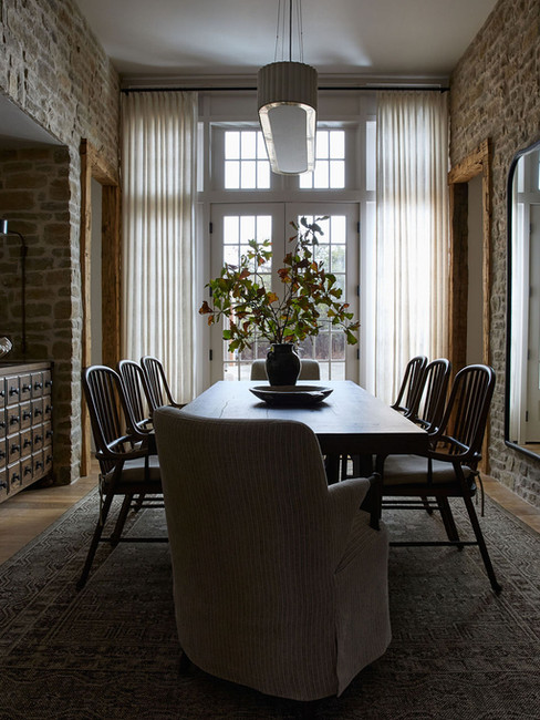 dining room with stone walls
