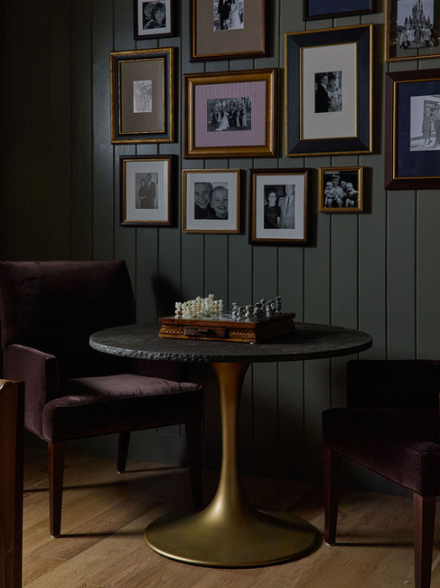 chess table in the study with family photo gallery wall