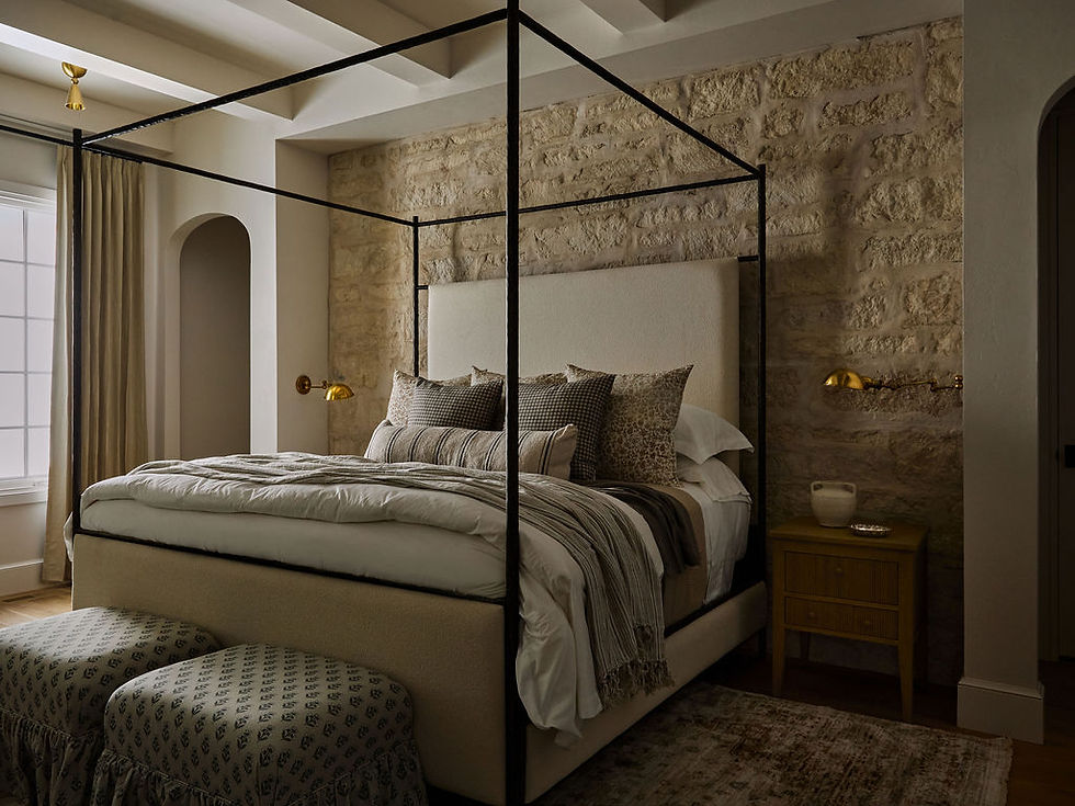 Traditional primary bedroom with layered neutral bedding, canopy bed, and timeless luxury design.