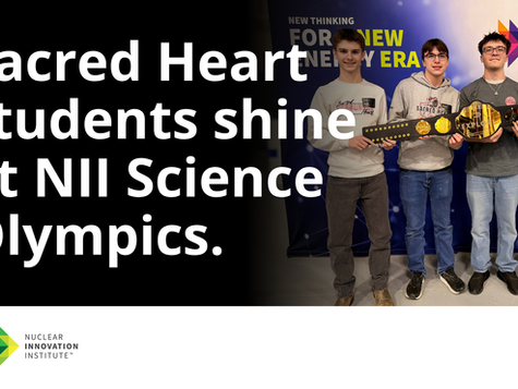 Four students hold a championship belt at the NII Science Olympics. Text reads "Sacred Heart students shine at NII Science Olympics." Nuclear Innovation Institute logo.