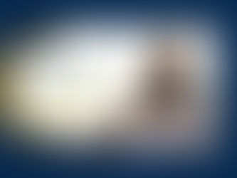 A woman sitting on the coach with a journal reflecting on her wins