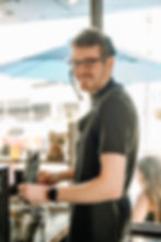 Will smiling and serving coffee