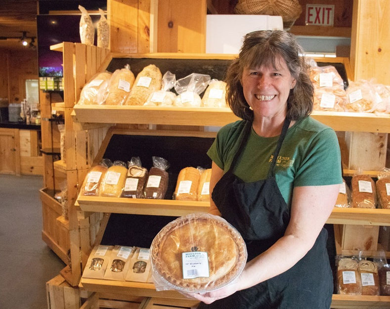 farm bakery team holding a freshly baked pie