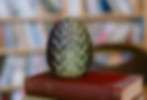 A stack of books with a dragon egg