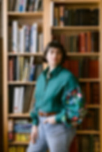 Lizzy Saxe standing in front of a bookshelf