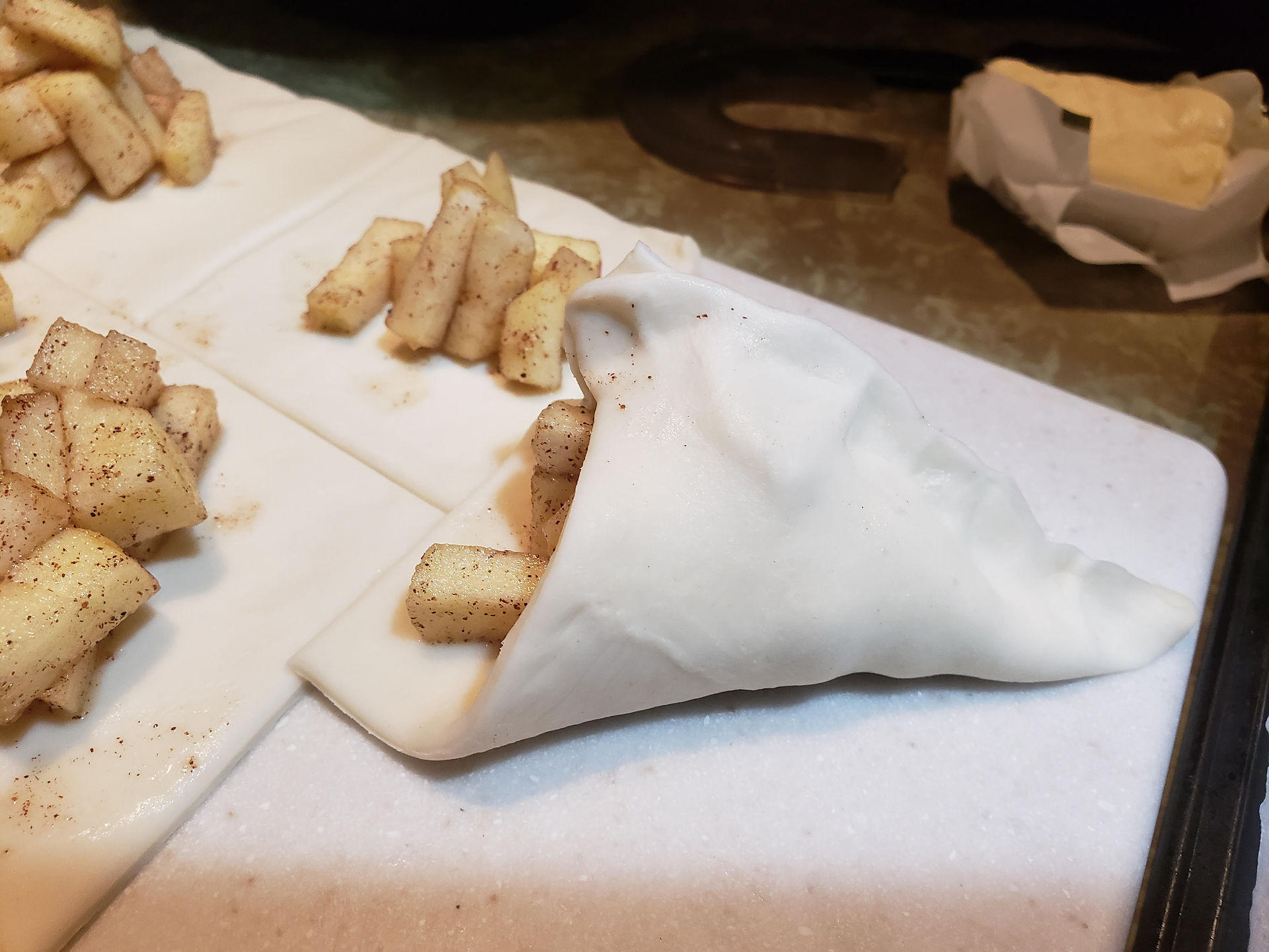 Apple pieces preparing to be wrapped in pastry squares for Quick & Easy Apple Turnovers.
