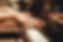 Close up of hands playing a piano.