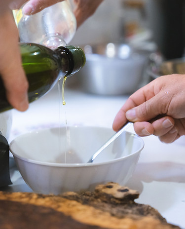 pouring and warming massage oil with hands