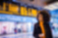 Smiling woman using mobile phone at the airport