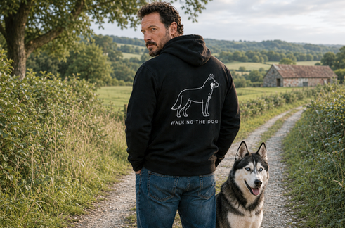 Man wearing a custom-made black Walking the Dog hoodie with husky artwork on the back