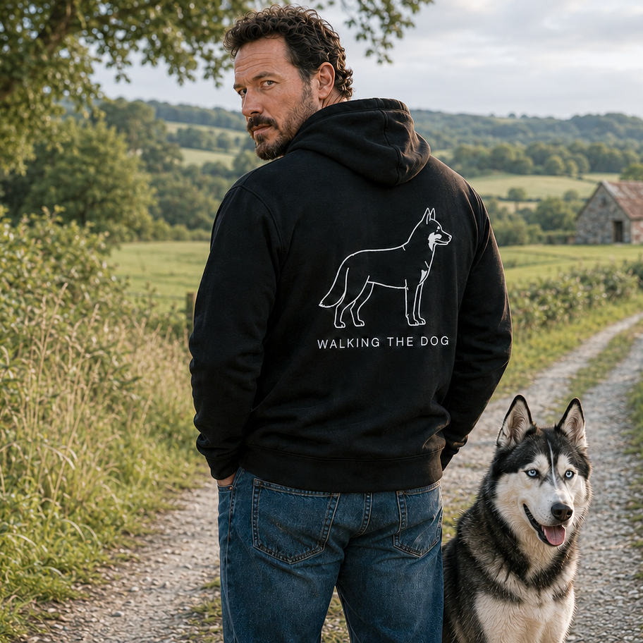 Man wearing a custom-made black Walking the Dog hoodie with husky artwork on the back