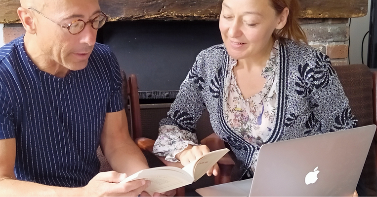 Private French tutor guiding student during one-on-one lesson in calm Parisian apartment