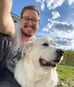 Kit, dog hiker and dog trainer with Sarah’s Pet Services, spending time with his dog Wrynn during an outdoor hike in Massachusetts.