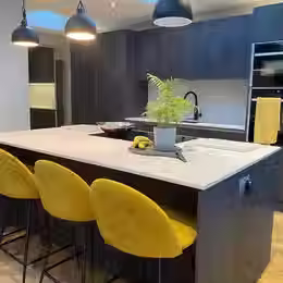Modern kitchen with yellow stools