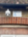A new CCTV camera installed on the side of a home, exposed brick work and a sign with ICOL on it