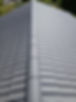 Looking down the central ridge of a grey tiled roof