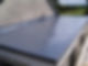 Finished smooth grey flat roof overlooking green trees and countryside