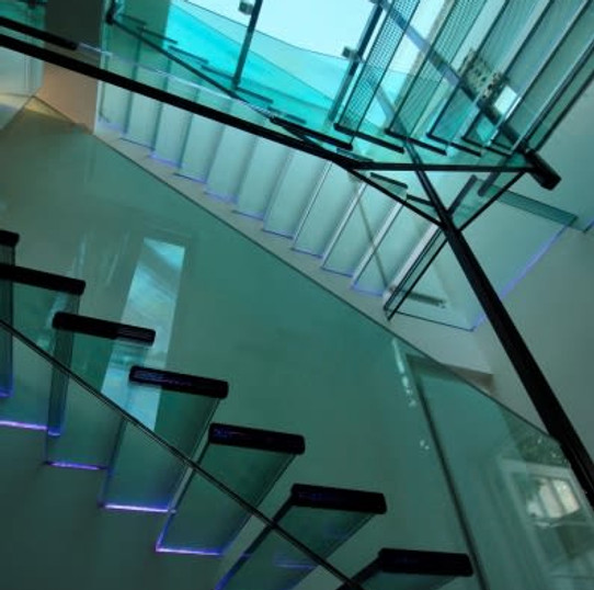 Contemporary glass and metal floating staircase viewed from below