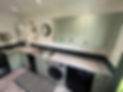 L-shaped kitchen showing the transformation from old cabinets to a fresh mint green vinyl finish
