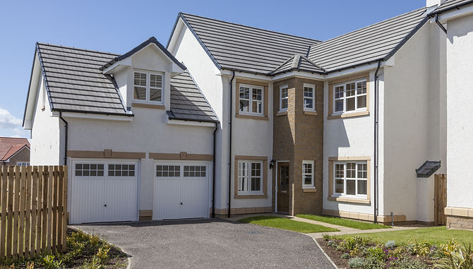 White rendered house featuring newly installed grey roof tile gable ends