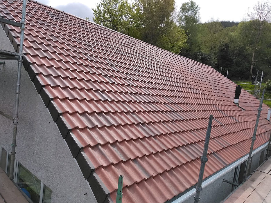 Close-up view of red interlocking roof tiles on a residential property