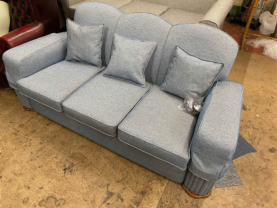 Large grey sofa reupholstered in patterned fabric