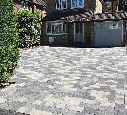 Grey block paved driveway outside a residential UK property