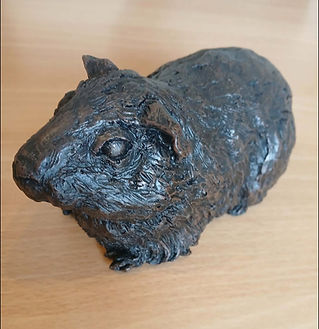 Small bronze pet memorial urn shaped like a sitting animal