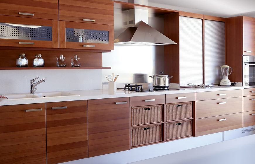 Large kitchen with dark wood effect vinyl wrapped base units and integrated woven storage baskets