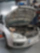 Silver Ford car with bonnet open undergoing a comprehensive vehicle service in the garage