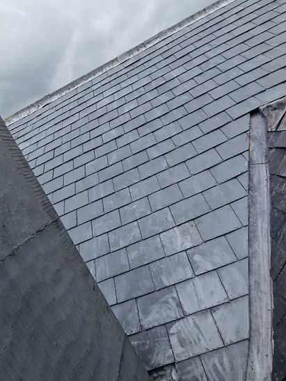 Traditional slate roof tiling with lead flashing details