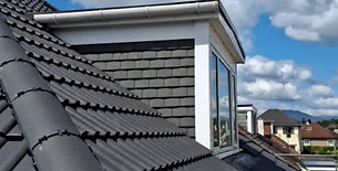 Close up of dark grey roof tiles on a house