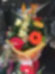 Vibrant floral arrangement with orange gerberas and red anthurium in yellow wrap