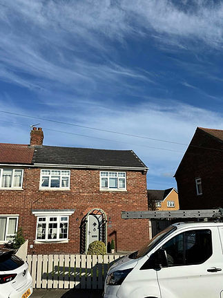 Two-storey red brick semi-detached house with a new grey tiled roof and white window frames