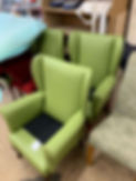 Green wingback armchairs reupholstered in bright fabric
