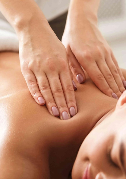 Professional massage therapist performing a relaxing back massage