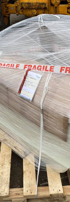 Securely packaged silver car bumper panel on pallet