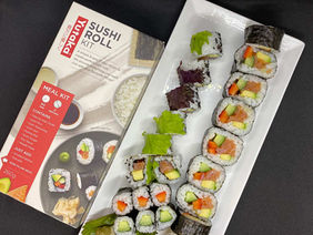 Packaged maki sushi rolls with branding for corporate event catering