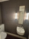 Modern bathroom with twin wall lights and a large mirror