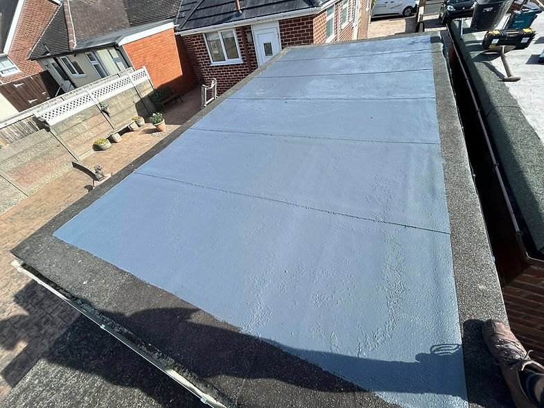 View of a flat, newly coated blue roof surrounded by a dark edge