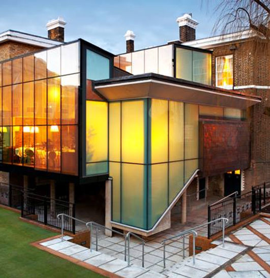 Multi-storey modern building exterior with structural glass facade and balconies