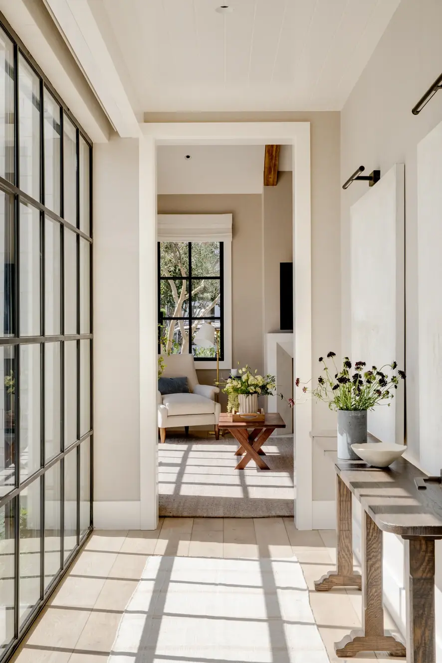 Bright hallway with wall of windows and console table