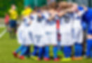 Coach giving young soccer team instructions. Youth soccer team together before final game.