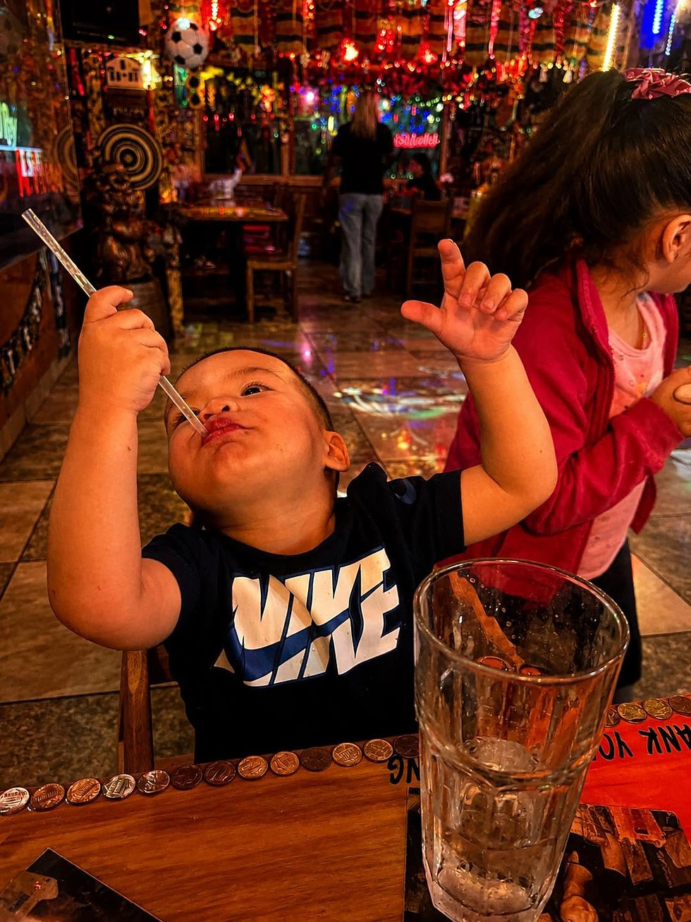Child enjoying a family meal at a restaurant, creating memories around food